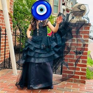 An elegant black dress for girls in 6-7sizes with a tail